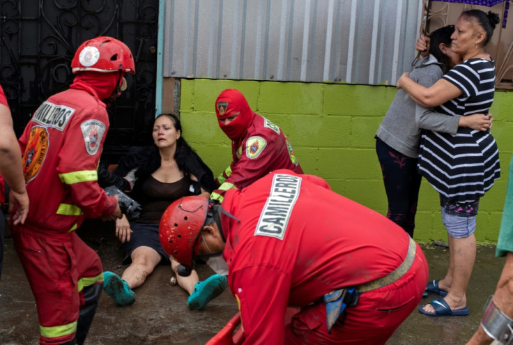 Volunteers carry a woman in a stretcher