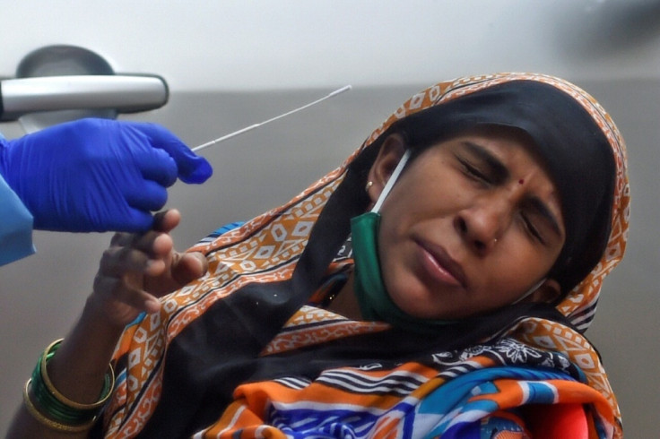 Health worker prepares to collect swab sample