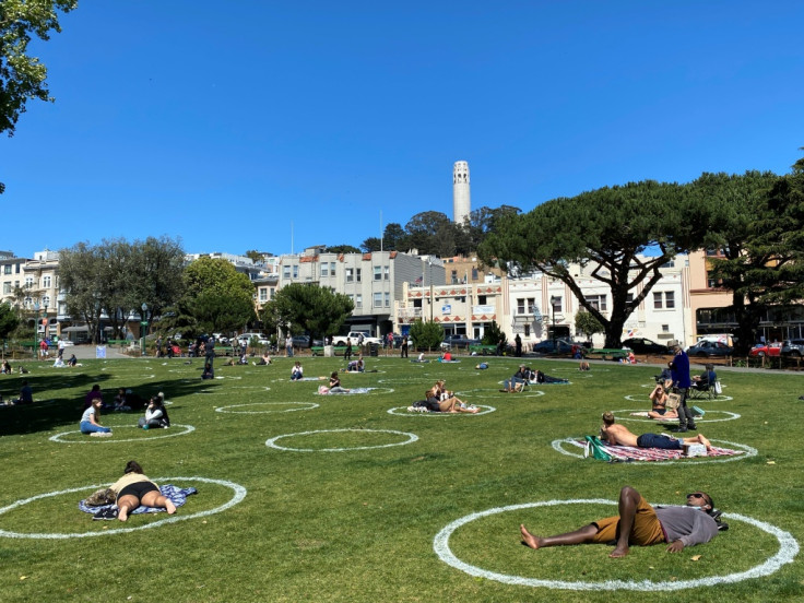 People practice social distancing in a park