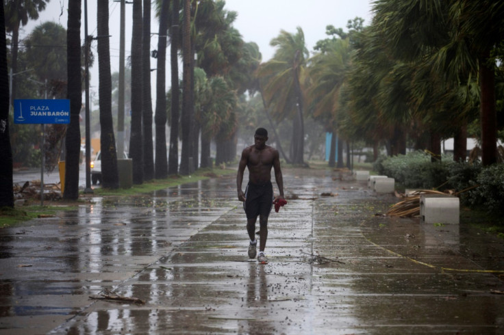 A man walks in pouring rain