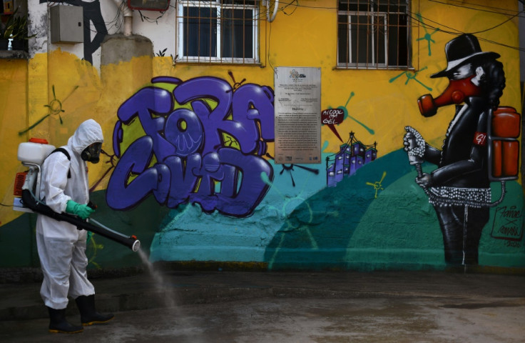 A volunteer disinfects an area