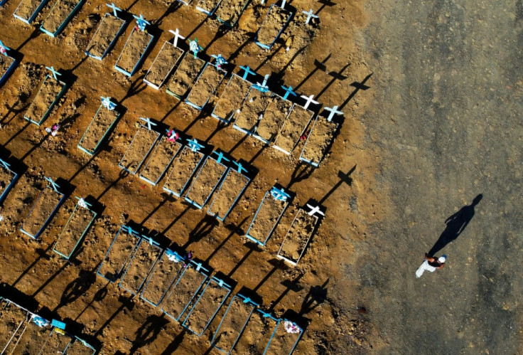 A man walks past graves