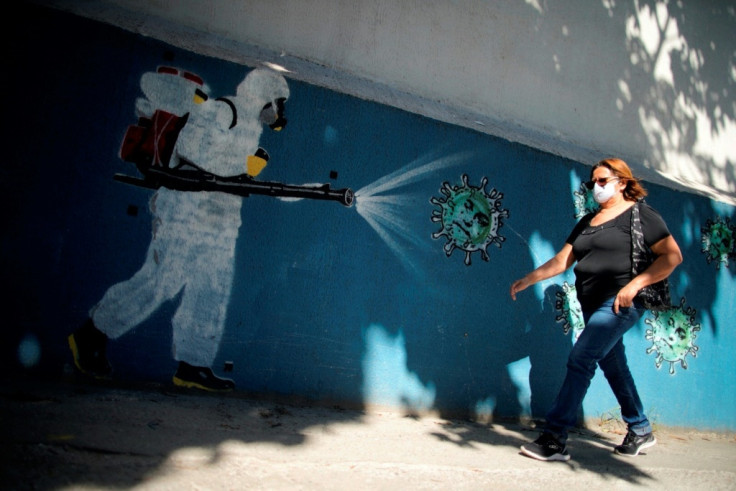 A woman walks past a mural