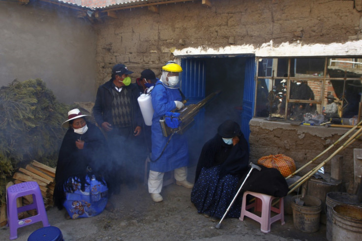 A funerary employee in protective gear