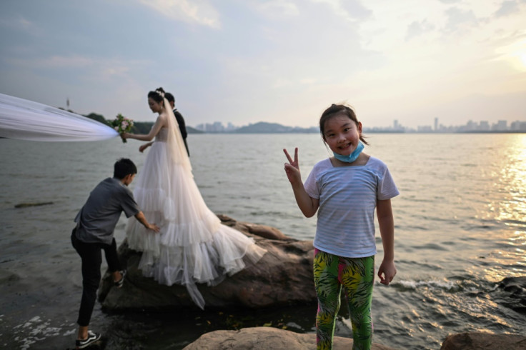 A couple poses for wedding photos