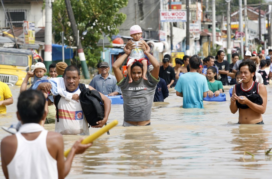 Villagers Wade Through Floodwaters After Typhoon Nalgae Hit The Philippines, In Calumpit