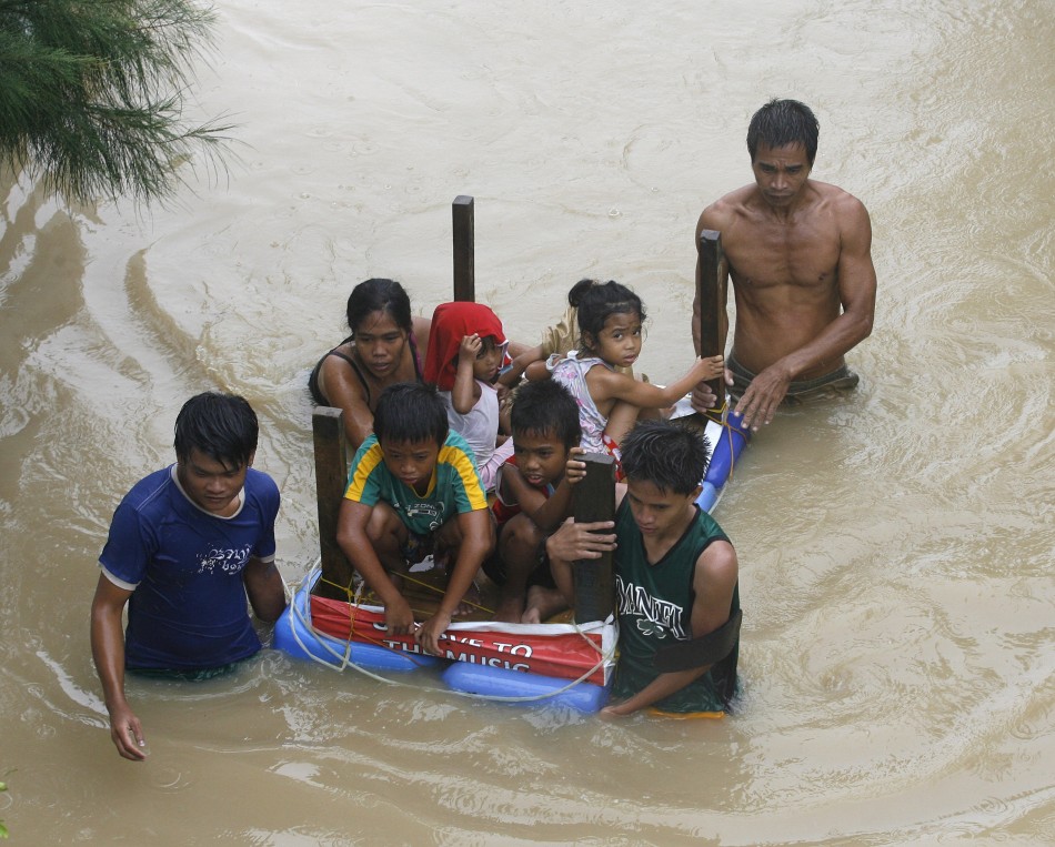 Typhoon Nalgae Hits Philippines - 04 Oct 2011 9 A Family Uses A Table As A Makeshift Raft To Evacuate Their Children