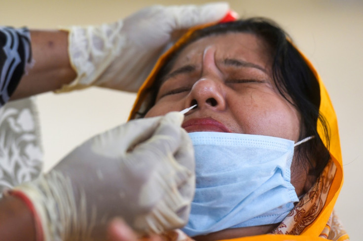 A woman taking a swab test