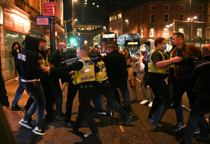 Police officers scuffle with revellers in Leeds