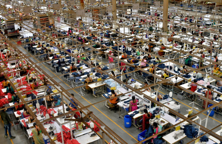 Garment workers stitch shirts at a textile factory of Texport Industries in Hindupur