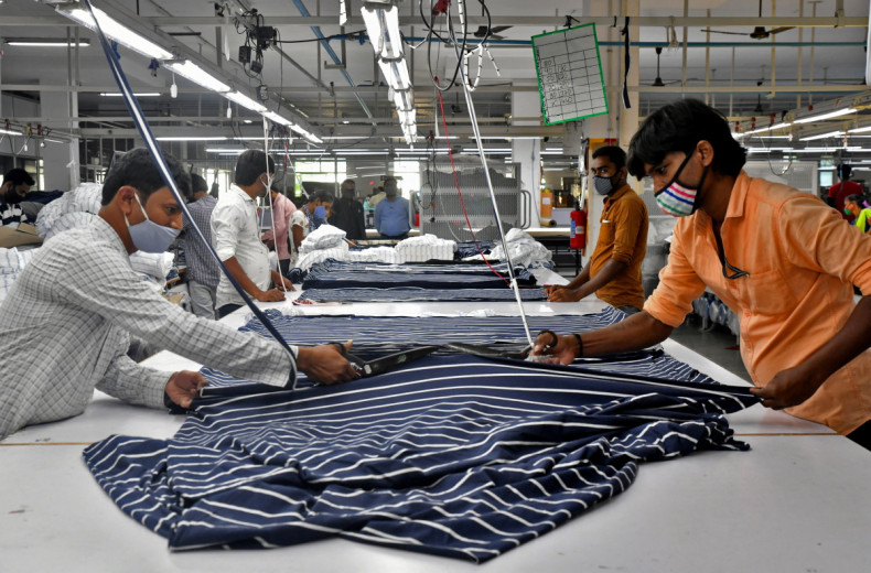 Garment workers cut fabric to make shirts at a textile factory of Texport Industries in Hindupur