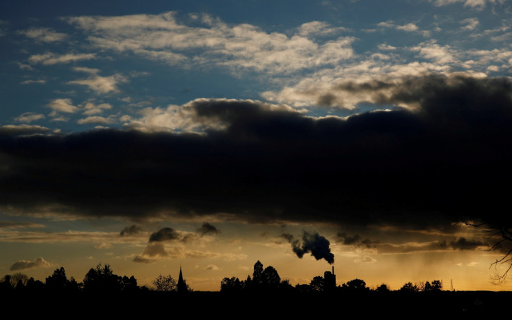 Smoke rises above a factory at sunset in Rugby