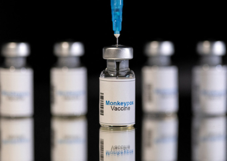 Illustration shows mock-up vials labeled "Monkeypox vaccine" and medical syringe