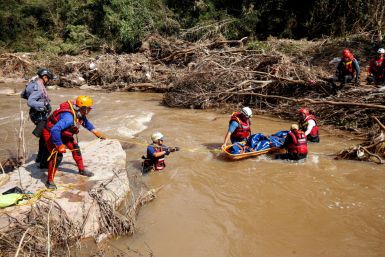 A  search and rescue team prepares to airlift a body from the Mzinyathi River after heavy rains caused flooding near Durban