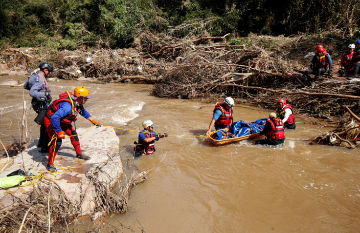 A  search and rescue team prepares to airlift a body from the Mzinyathi River after heavy rains caused flooding near Durban