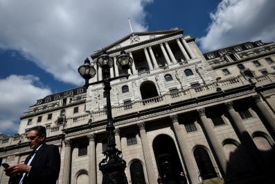 A man stands outside the Bank of England in the City of London
