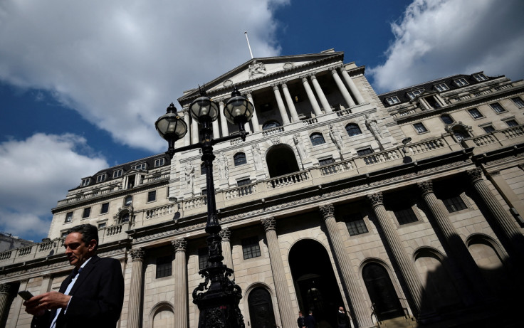 A man stands outside the Bank of England in the City of London