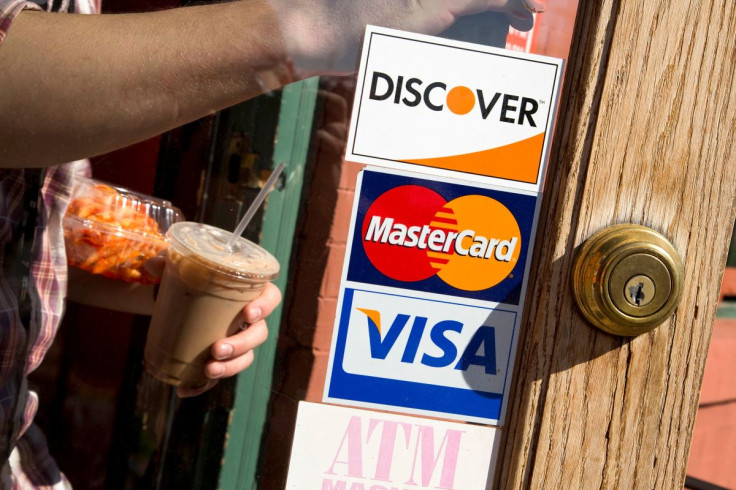 A coffee shop displays signs for Visa, MasterCard and Discover in Washington