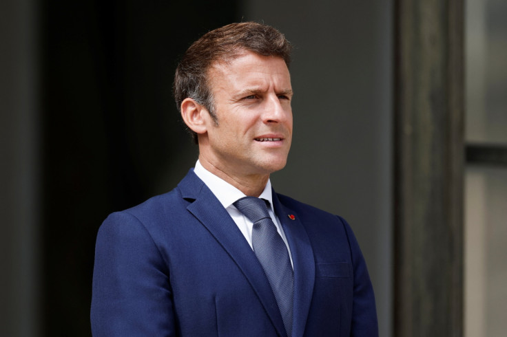 French President Emmanuel Macron welcomes a guest at the Elysee Palace in Paris