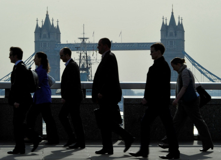 City workers cross London Bridge during the morning rush hour in London