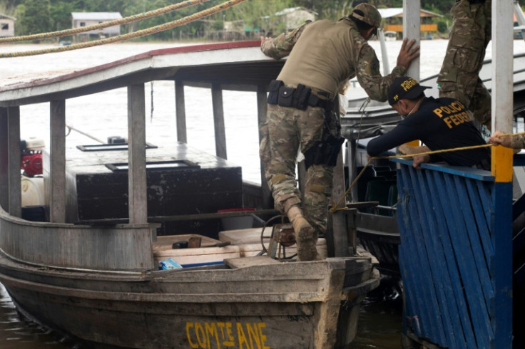 A Federal Police expert examines a boat seized by the task force searching for journalist Dom Phillips and indigenous expert Bruno Pereira, in Atalaia do Norte in Brazil's Amazonas state, on June 11, 2022