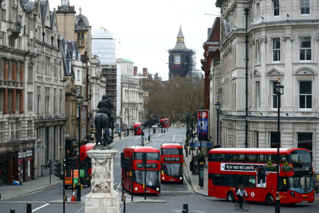 London buses travel along Whitehall in Westminster in London