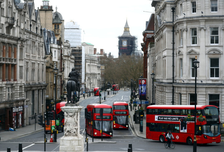 London buses travel along Whitehall in Westminster in London