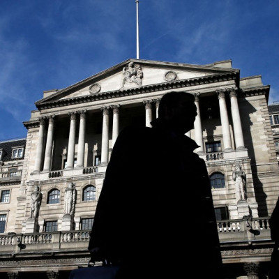 Pedestrians walk past the Bank of England in London