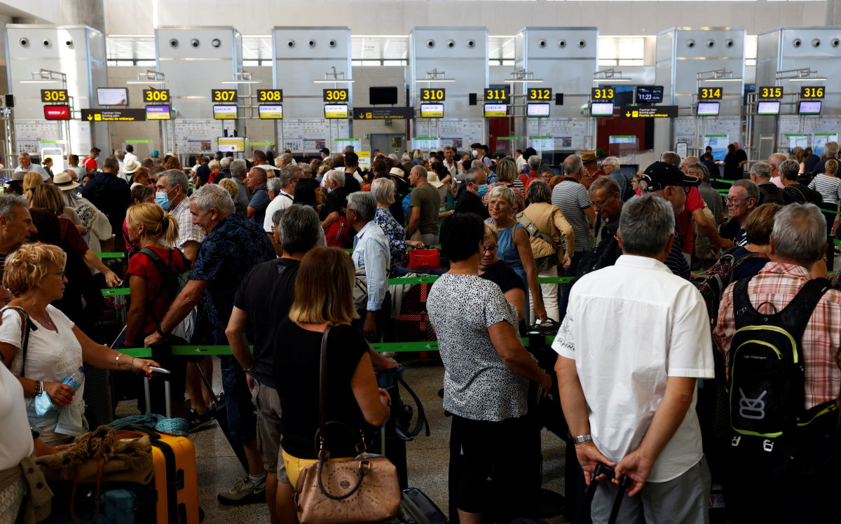 Passengers queue at check-in desks at Malaga-Costa del Sol Airport