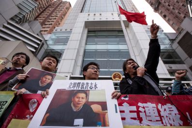 Protesters hold images of Chinese rights advocate Xu Zhiyong, during a demonstration calling for his release, in Hong Kong