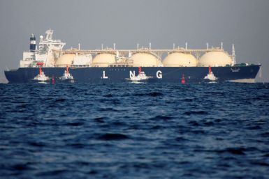 An LNG tanker is tugged towards a thermal power station in Futtsu