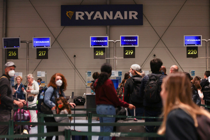 People wait on the Ryanair check-in line at Lisbon Humberto Delgado Airport