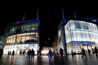 Shoppers are seen walking near Bullring shopping centre, owned by mall operator Hammerson, in Birmingham