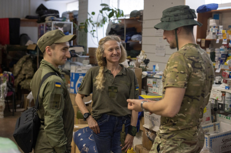 Tatiana Himeon, a volunteer who runs distribution centre for Ukrainian service members, talks to soldiers in Slovyansk