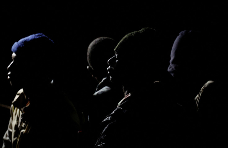 Migrants wait to disembark from a Spanish coast guard vessel, in the port of Arguineguin