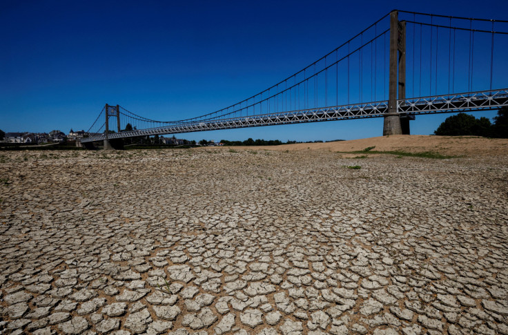 Cracked and dry earth is seen in the wide riverbed of the Loire River in Ancenis-Saint-Gereon