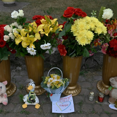 A makeshift shrine of candles, flowers and children's toys stands next to a destroyed mall in Kremenchuk on June 28, 2022, a day after it was hit by a Russian missile strike according to Ukrainian authorities.