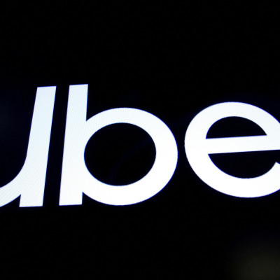 A screen displays the company logo for Uber Technologies Inc. on the day of it's IPO at the NYSE in New York
