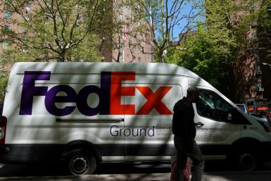 A person walks by a FedEx van in Manhattan, New York City