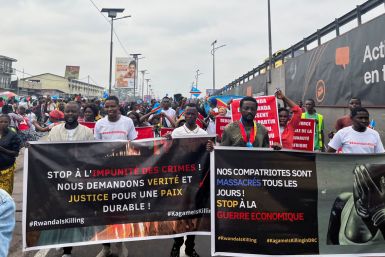 Civil society members hold banners during an anti-Rwanda protest amid tensions between Kinshasa and Kigali over Rwanda's suspected backing of the M23 rebel group, in Kinshasa,
