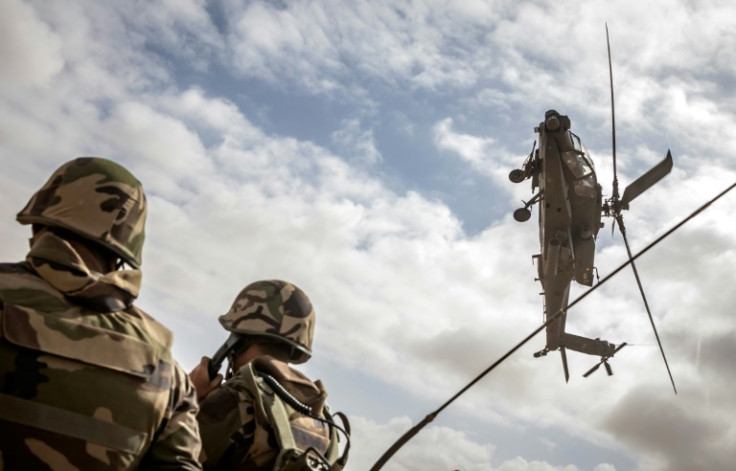 A US army AH-64 Apache attack helicopter flies over members of the Moroccan Royal Armed Forces during the second annual "African Lion" military exercise  on June 30