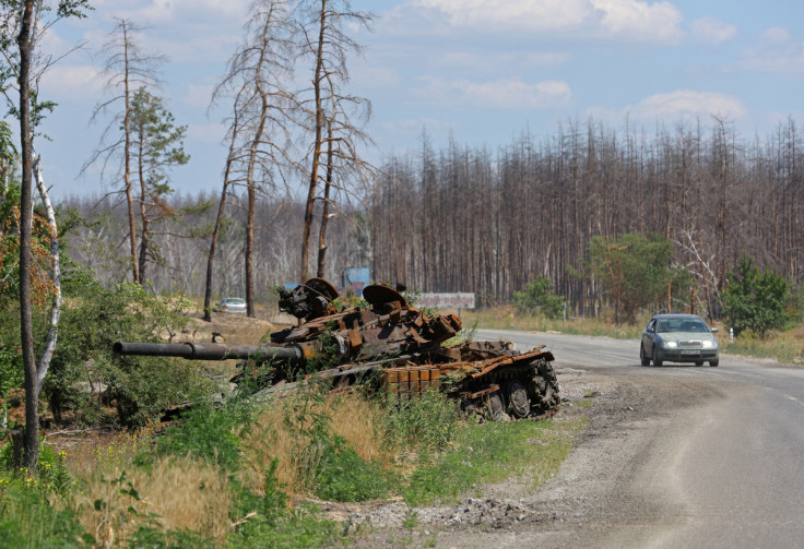 A view shows a destroyed tank alongside the road outside Sievierodonetsk