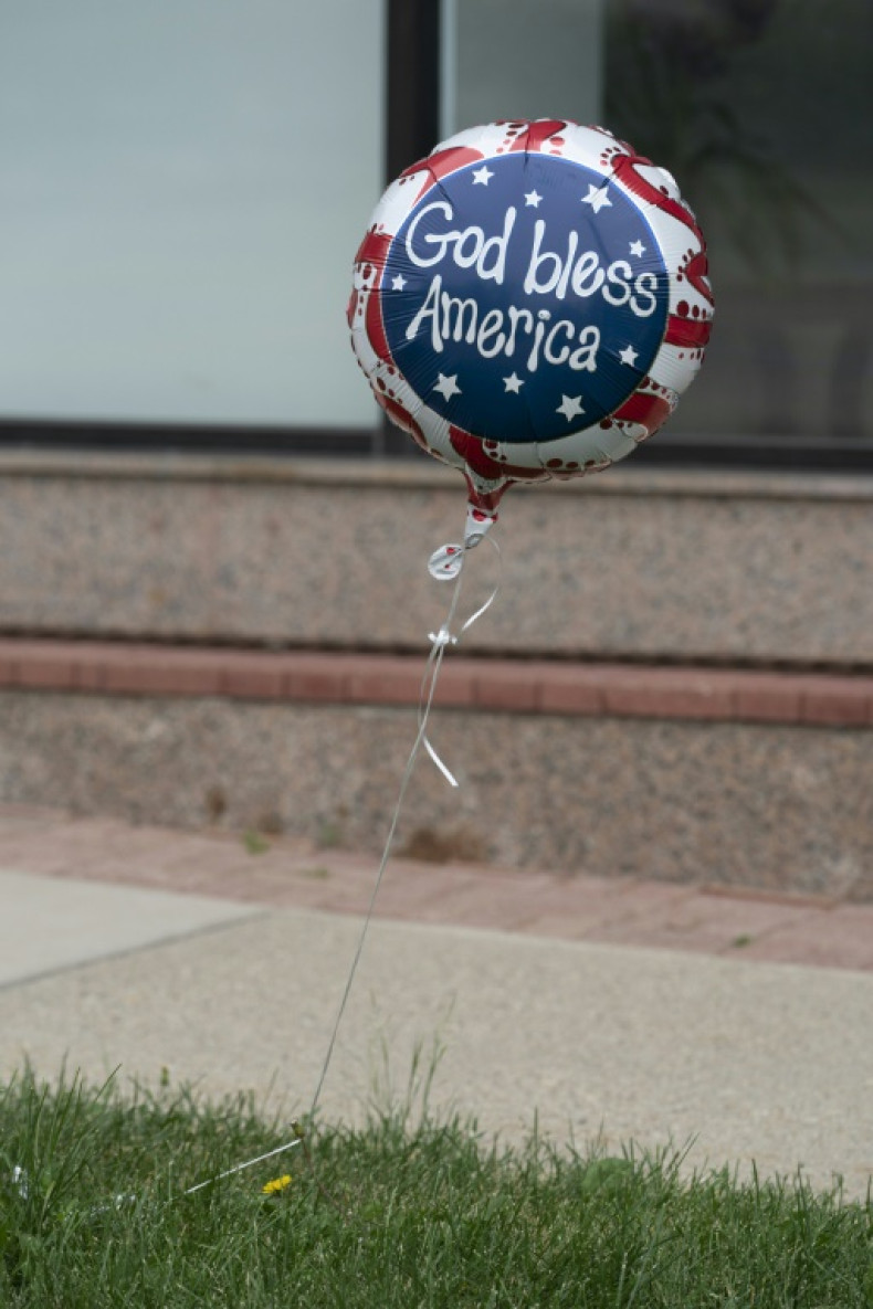 An Independence Day ballon with the words "God Bless America" is seen along the parade route at the scene of the Fourth of July parade shooting in Highland Park, Illinois on July 4, 2022