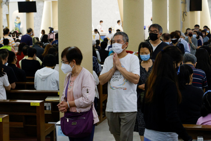 Catholic worshipers pray at a church, in Hong Kong