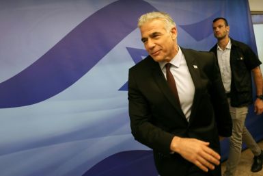 Israel's Prime Minister Yair Lapid arrives to attend the first cabinet meeting in Jerusalem on July 3: on Tuesday, Lapid is in Paris on his first foreign trip as premier