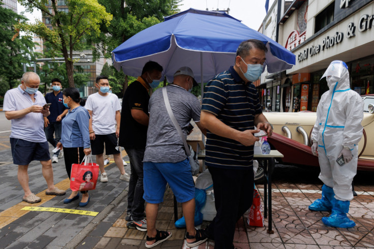 People line up at a nucleic acid testing station, following a coronavirus disease (COVID-19) outbreak, in Beijing