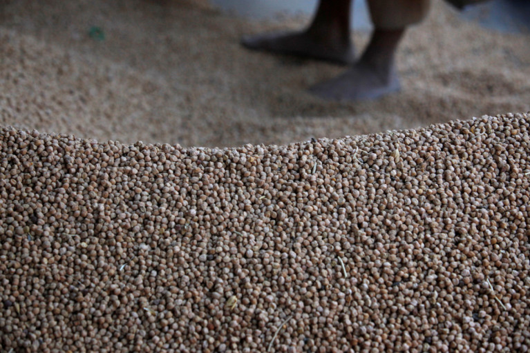 A mound of chickpeas is seen as they are packaged to sell at a wholesale market in Karachi