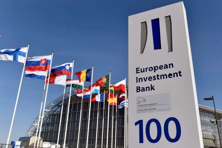 Flags are seen behind the logo of the EIB pictured in the city of Luxembourg