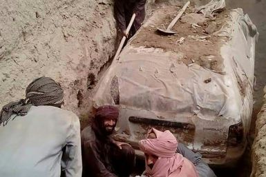 The white Toyota Corolla was buried in a village garden in Zabul province by Taliban official Abdul Jabbar Omari, who ordered it to be dug up this week. In this undated handout picture released by Taliban media officials on July 7, 2022, Taliban members
