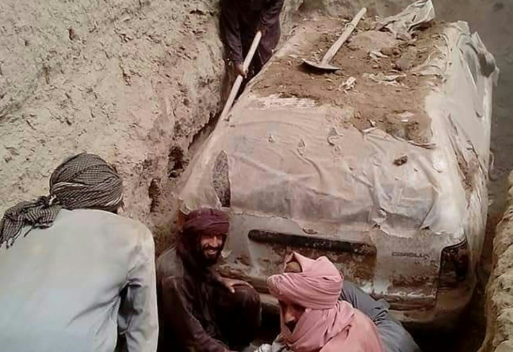 The white Toyota Corolla was buried in a village garden in Zabul province by Taliban official Abdul Jabbar Omari, who ordered it to be dug up this week. In this undated handout picture released by Taliban media officials on July 7, 2022, Taliban members